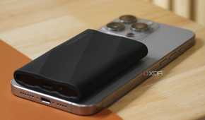 A side view of a Samsung SSD on top of an iPhone.
