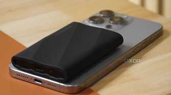 A side view of a Samsung SSD on top of an iPhone.