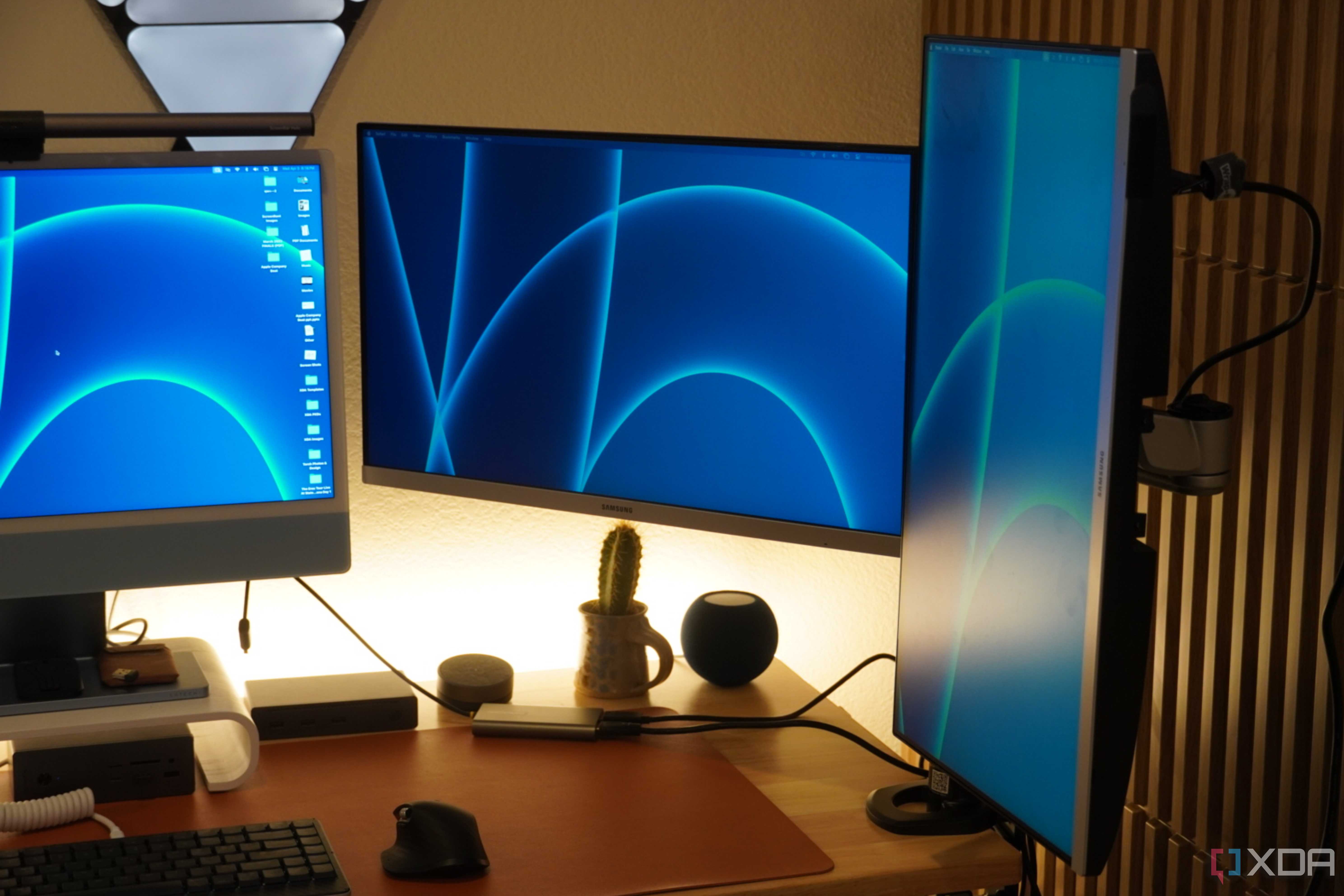 Two monitors mounted on a StarTech Dual Monitor Arm.