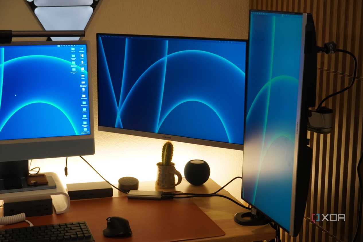 Two monitors mounted on a StarTech Dual Monitor Arm.