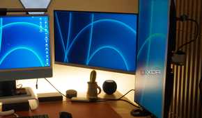 Two monitors mounted on a StarTech Dual Monitor Arm.