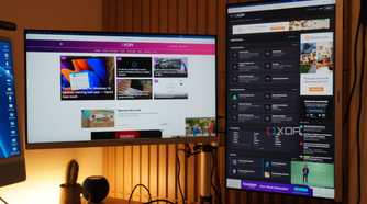 The XDA homepage and forums on monitors on a StarTech mount.