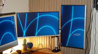 The StarTech monitor arm showing one horizontal and one vertical monitor.