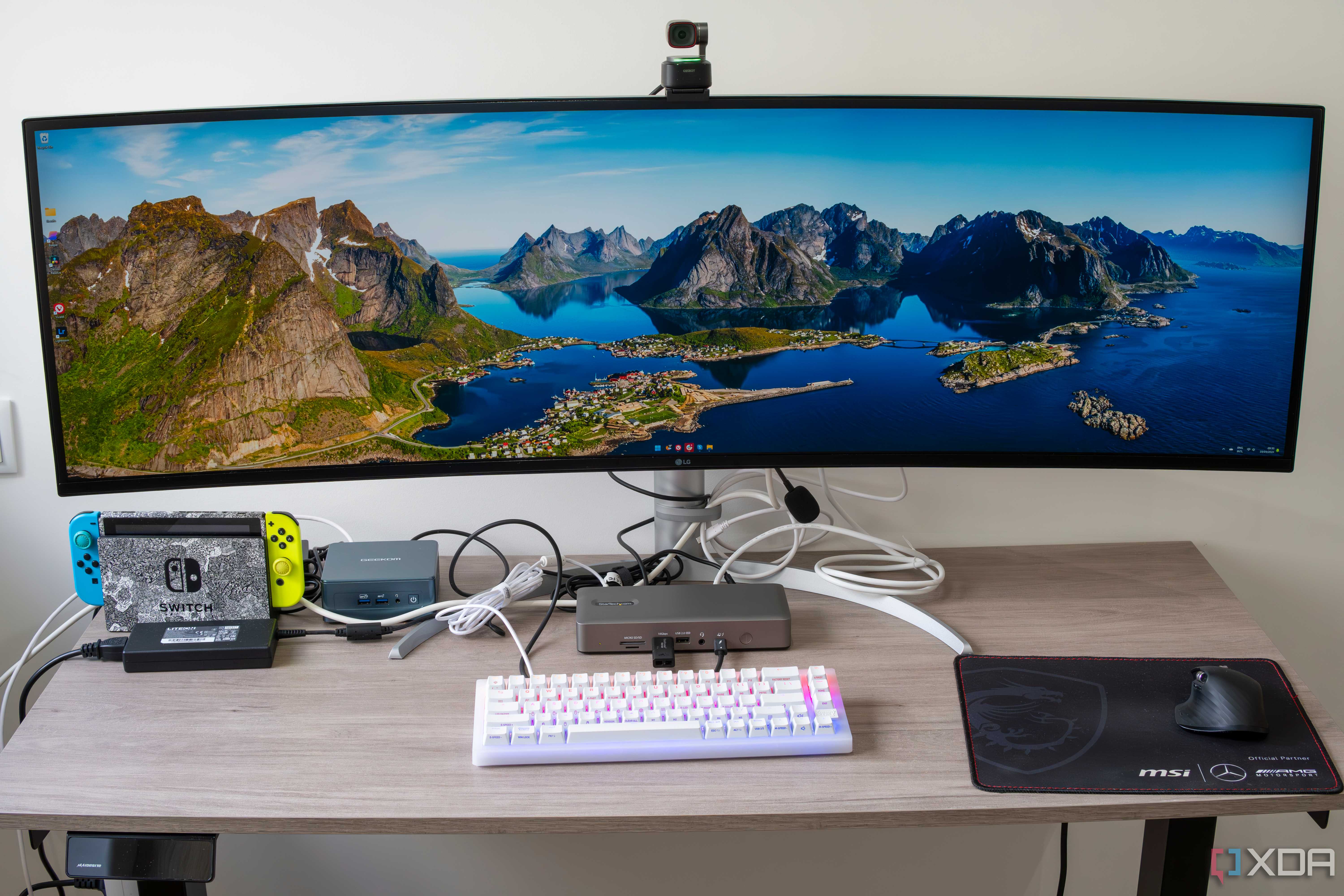 A desk setup with a mini PC and multiple peripherals connected to the StarTech Thunderbolt 4 Multi-Display Docking Station