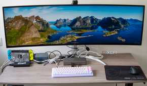A desk setup with a mini PC and multiple peripherals connected to the StarTech Thunderbolt 4 Multi-Display Docking Station