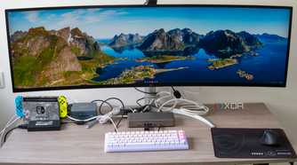 A desk setup with a mini PC and multiple peripherals connected to the StarTech Thunderbolt 4 Multi-Display Docking Station