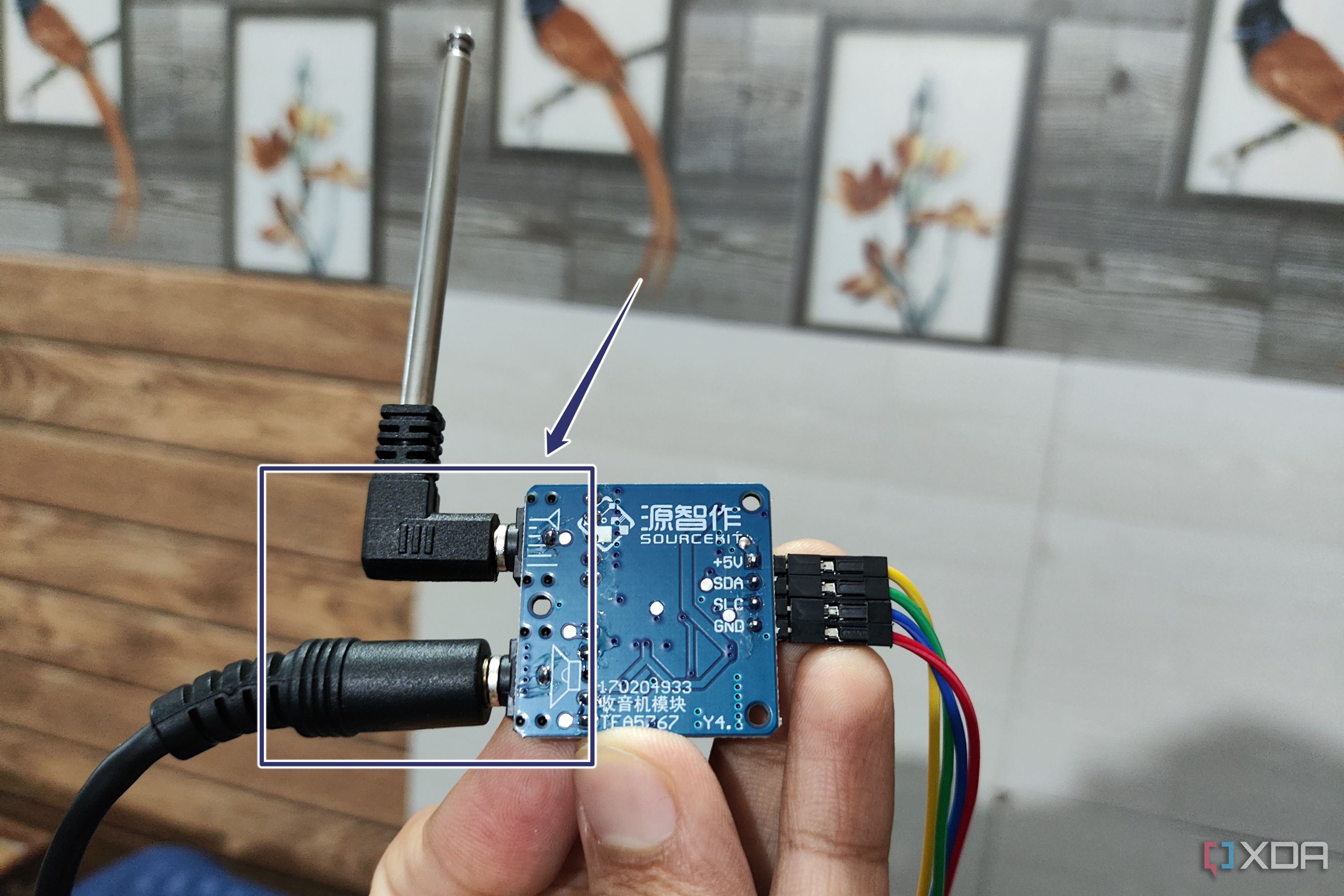A TEA5767 module with the headphones and antenna plugged in