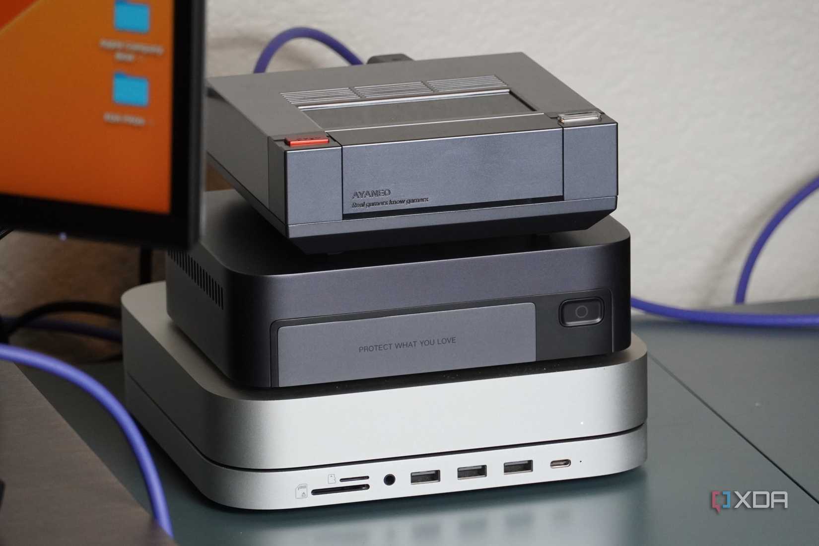 The Ugreen NAS sandwiched between an Ayaneo Mini PC and Mac Mini.