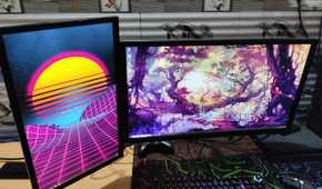 A normal monitor and a vertical monitor mounted on the same monitor arm