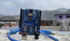 An Arduino Uno board with a cable wrapped around it