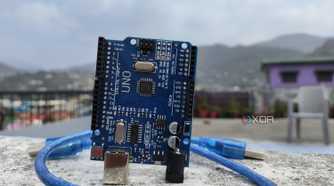 An Arduino Uno board with a cable wrapped around it