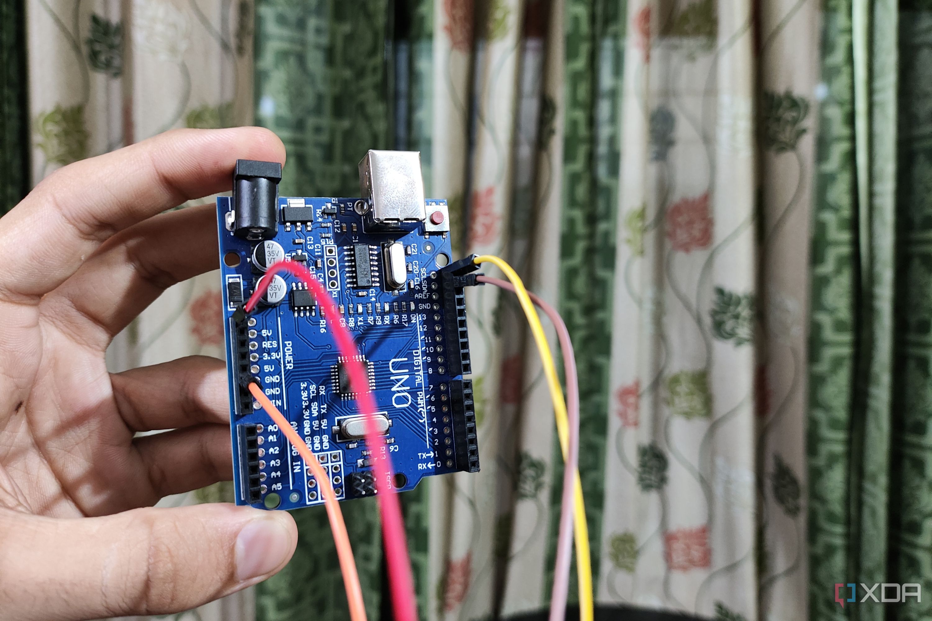 An Arduino Uno with Jumper cables plugged in