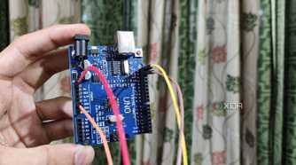 An Arduino Uno with Jumper cables plugged in