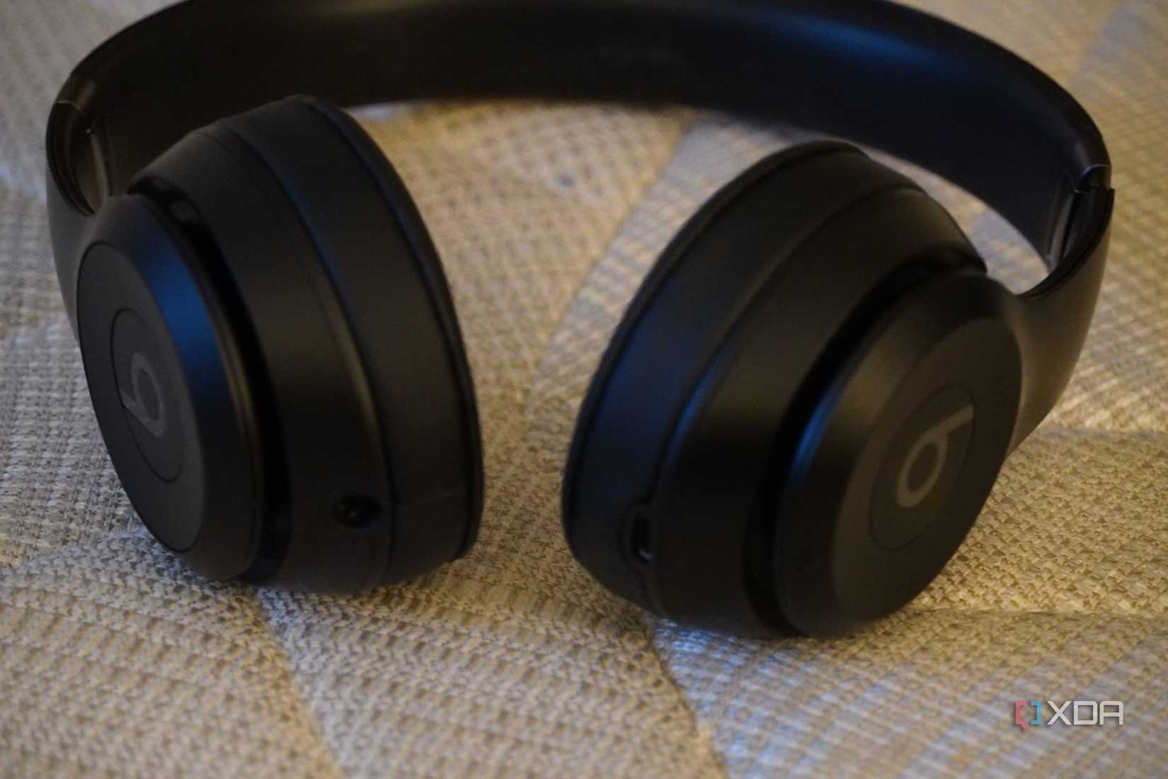 Beats headphones on a couch.