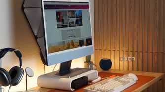 A desk setup featuring the BenQ ScreenBar Pro.