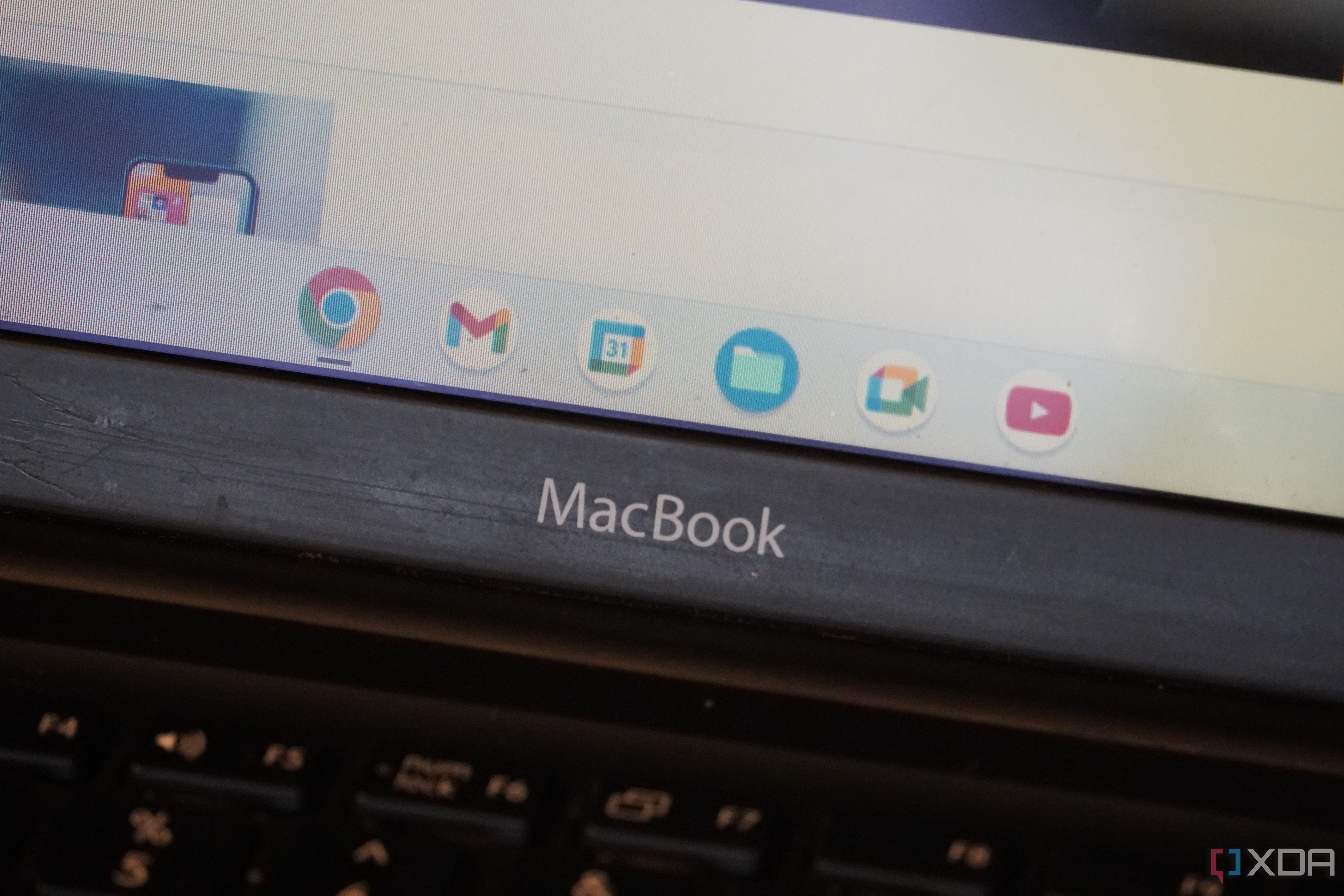The ChromeOS dock above the MacBook text.