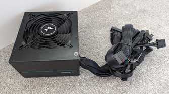 The underside of a DeepCool PM500D power supply with non-modular cables bundled together