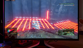 A game with vibrant colors being shown on the Dell AW3225QF.