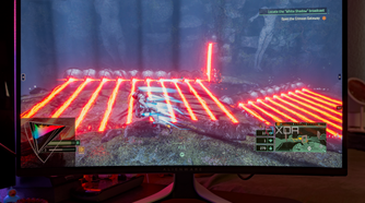 A game with vibrant colors being shown on the Dell AW3225QF.