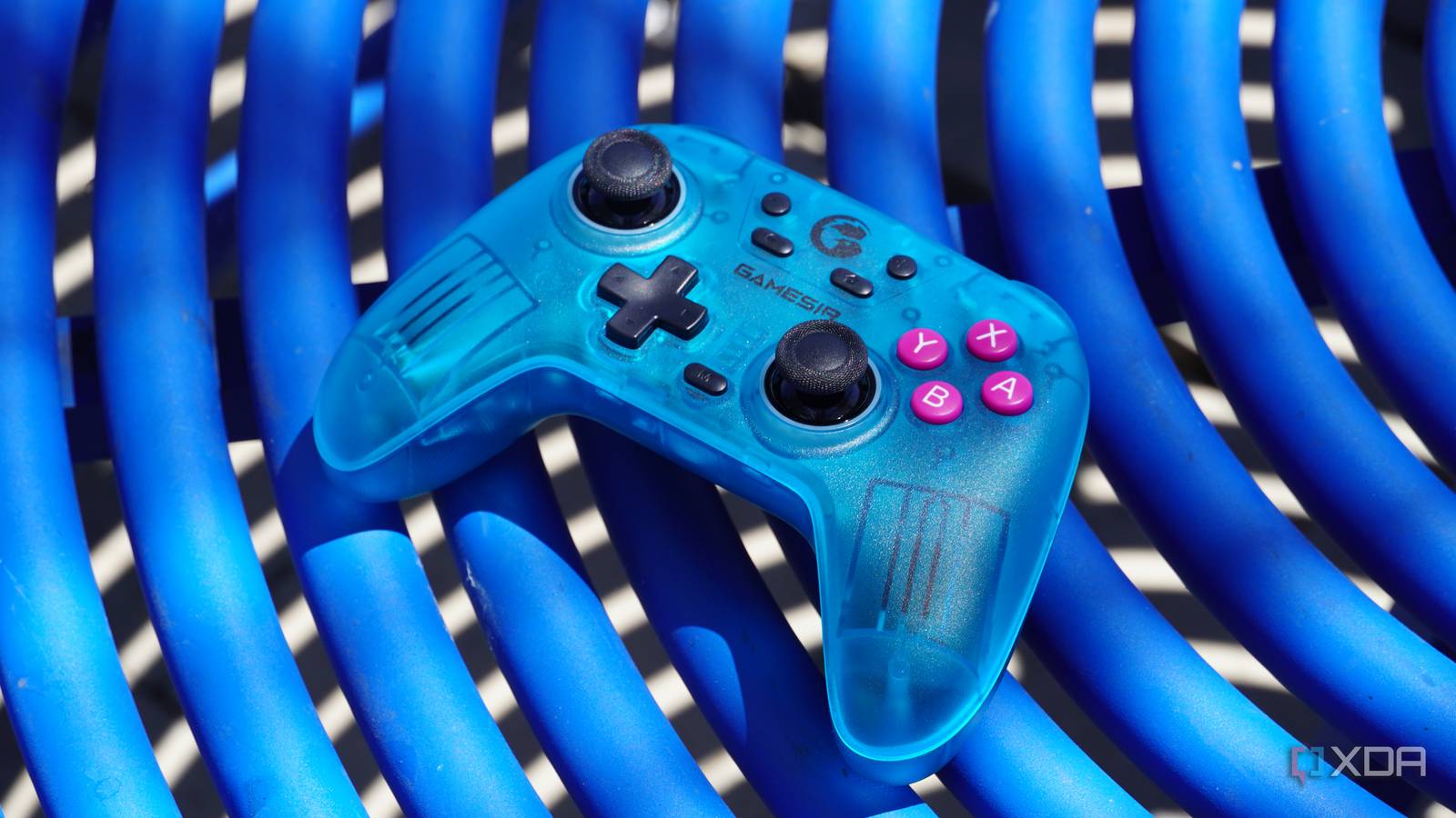 The GameSir Nova game controller on a blue table.