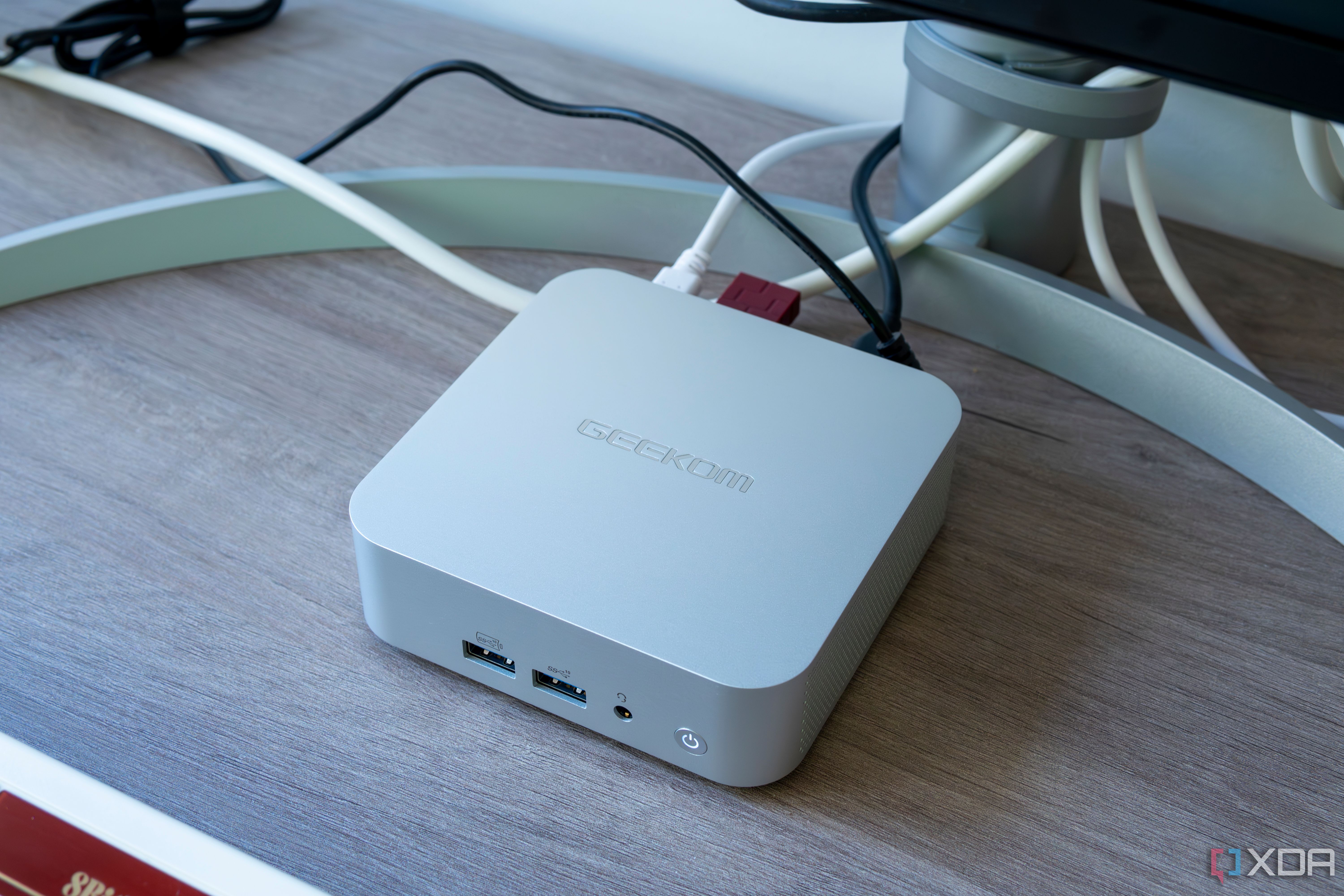 Angled view of the Geekom A8 mini PC with multiple peripherals connected