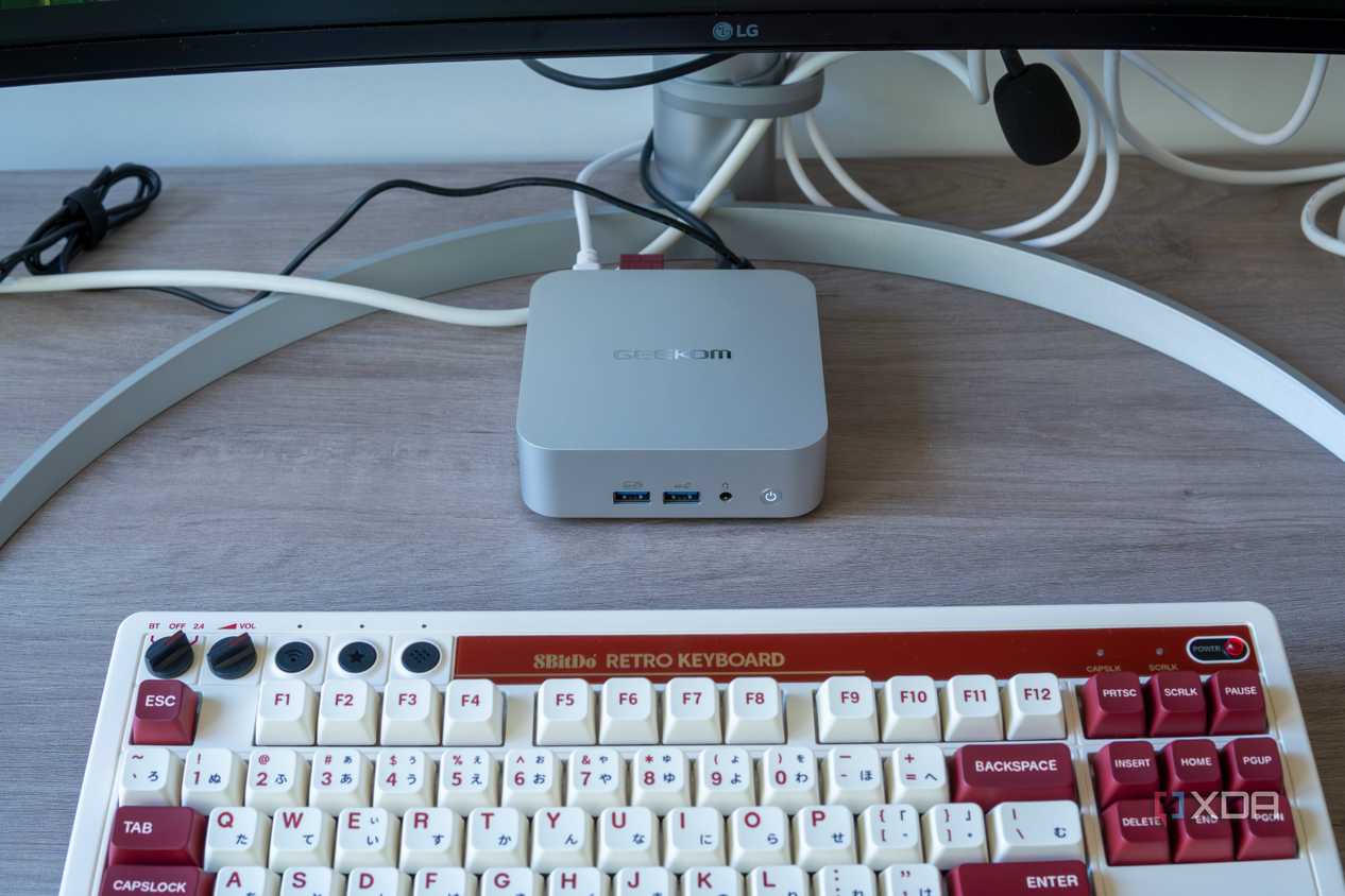 A Geekom A8 mini PC with a keyboard in front of it