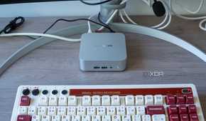 A Geekom A8 mini PC with a keyboard in front of it