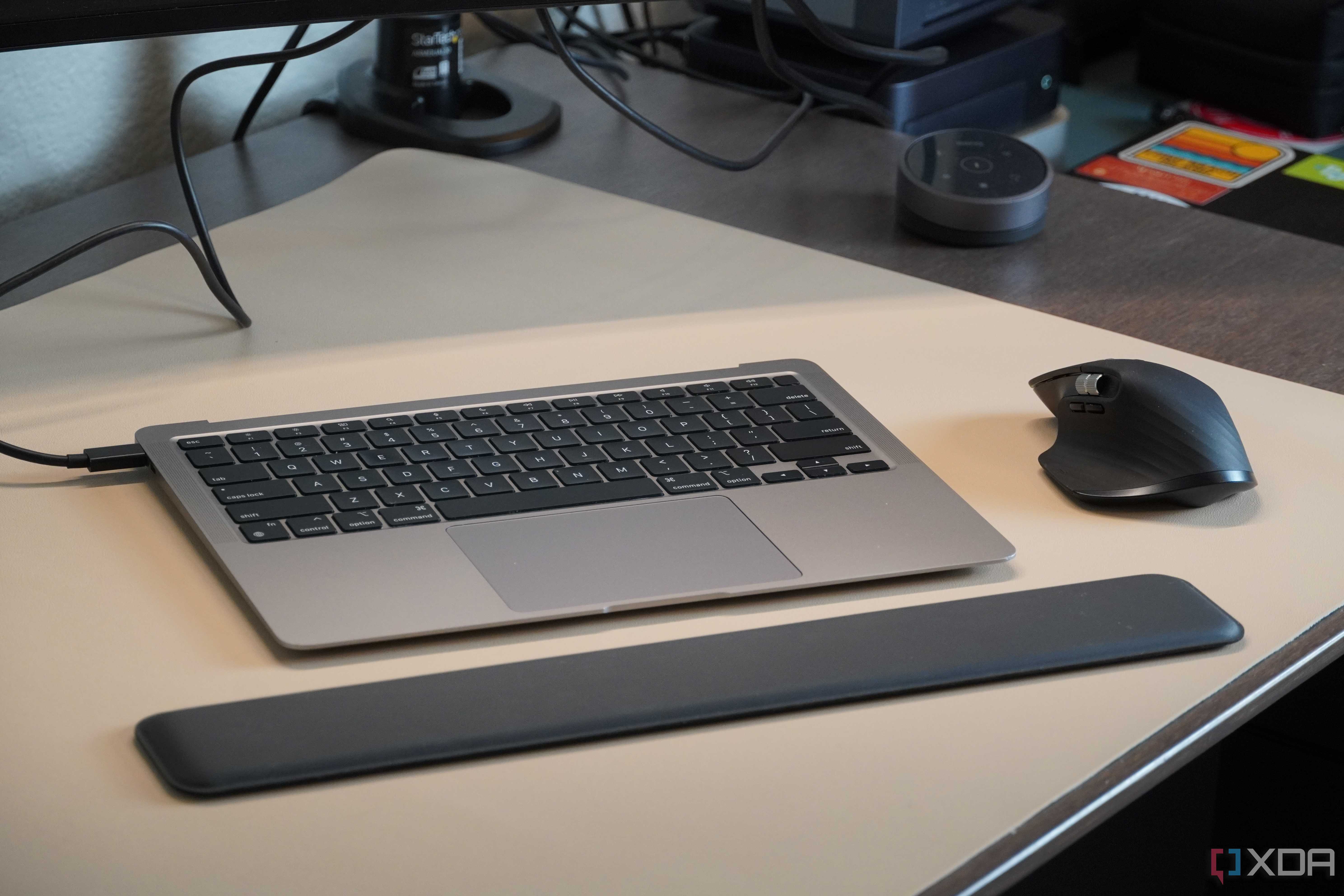 A MacBook Air without a screen with a wrist rest and mouse.