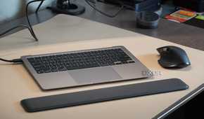 A MacBook Air without a screen with a wrist rest and mouse.