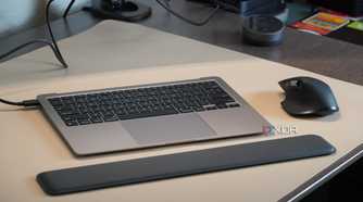 A MacBook Air without a screen with a wrist rest and mouse.