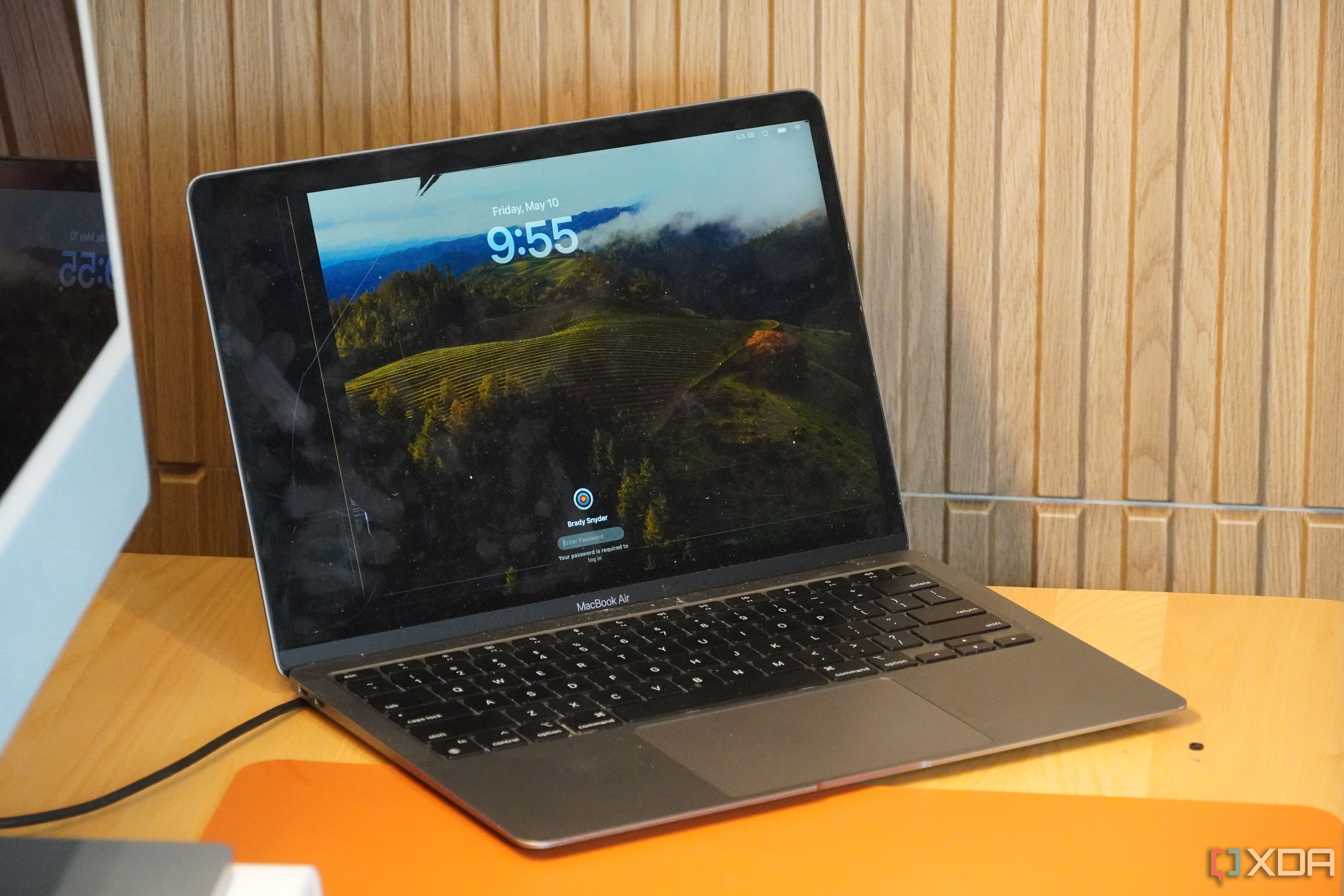 A cracked MacBook display on a desk.