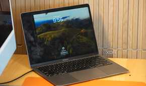 A cracked MacBook display on a desk.
