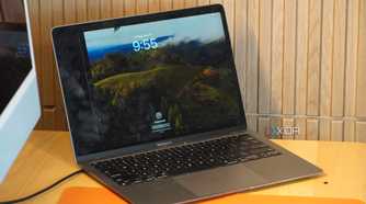 A cracked MacBook display on a desk.