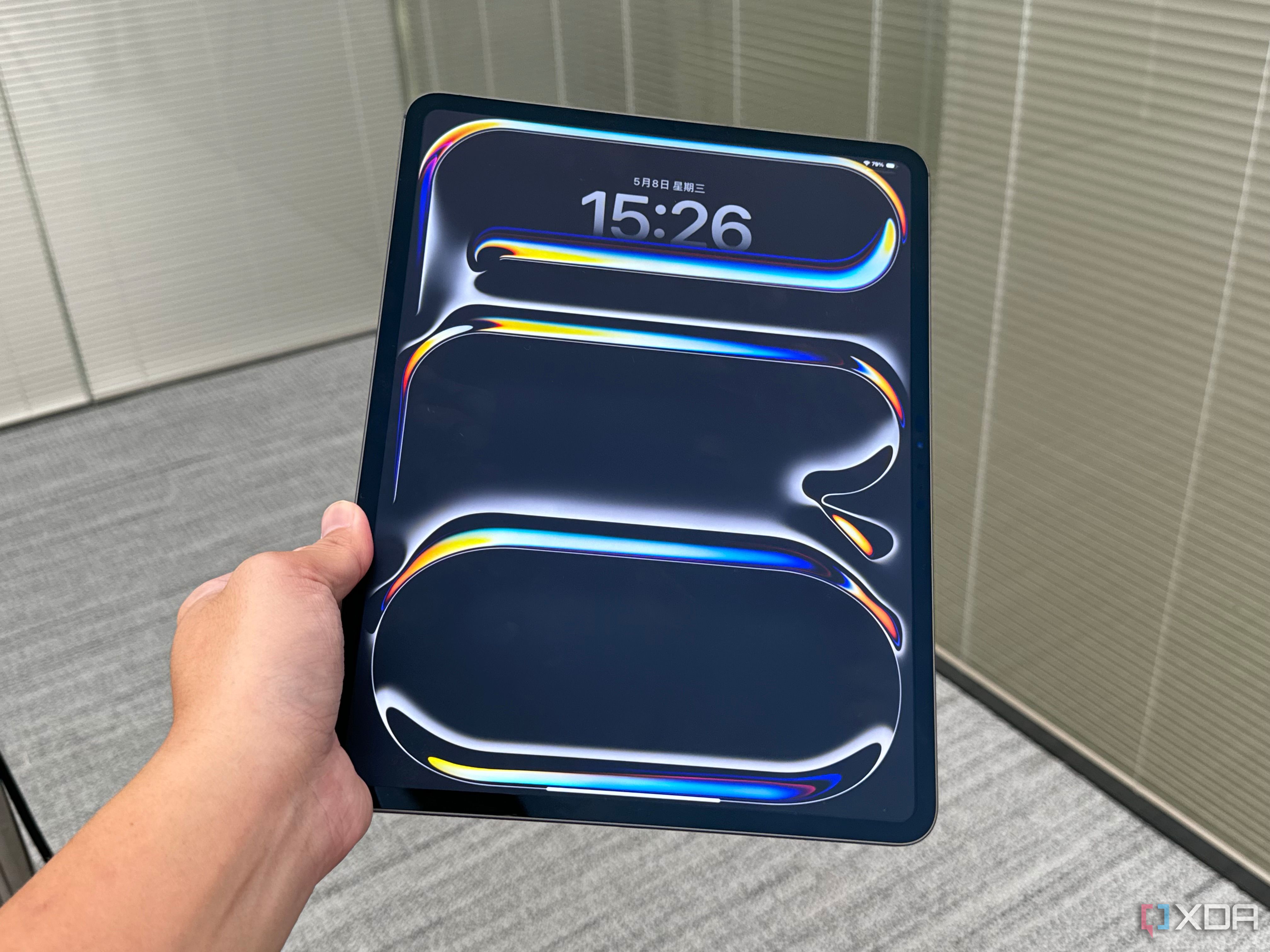 A 2024 iPad Pro held in a person's hand