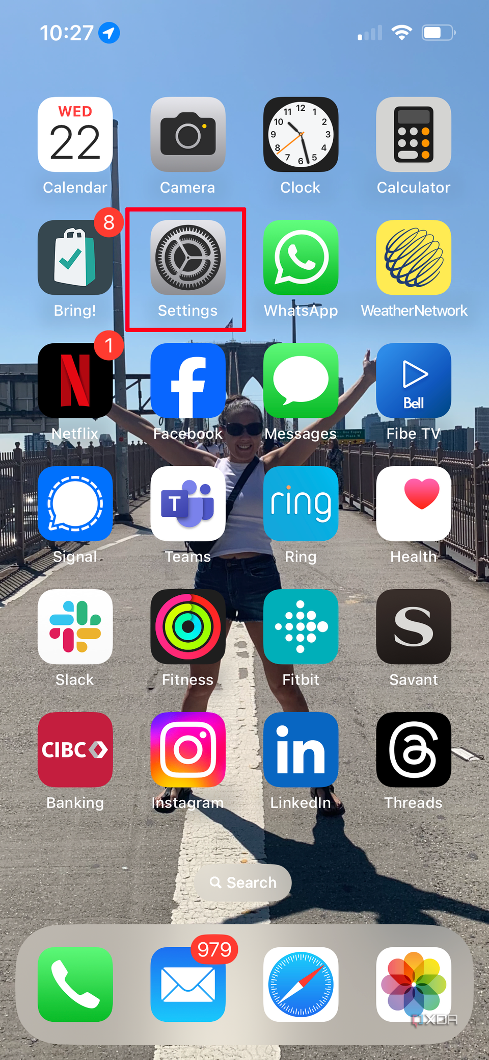 iPhone home screen with the Settings icon selected.