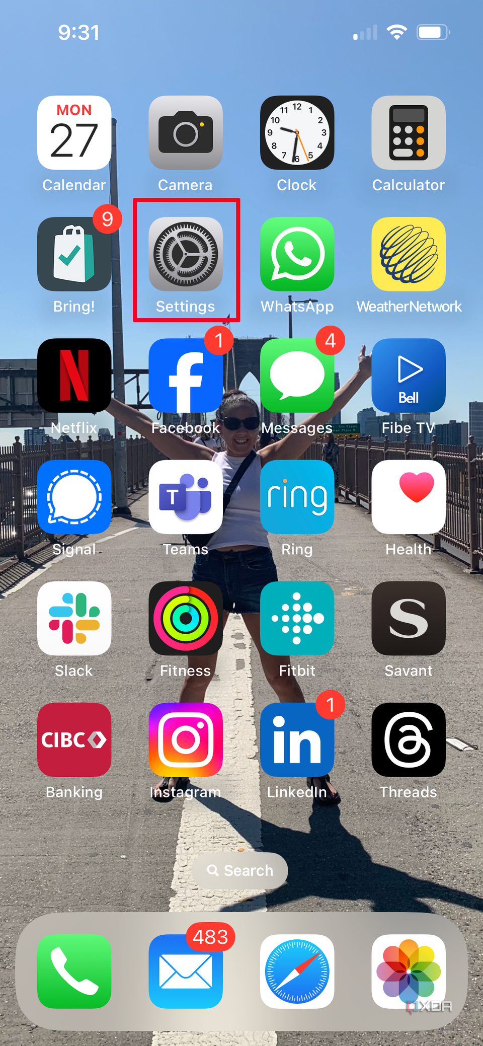 An iPhone home screen with Settings selected.
