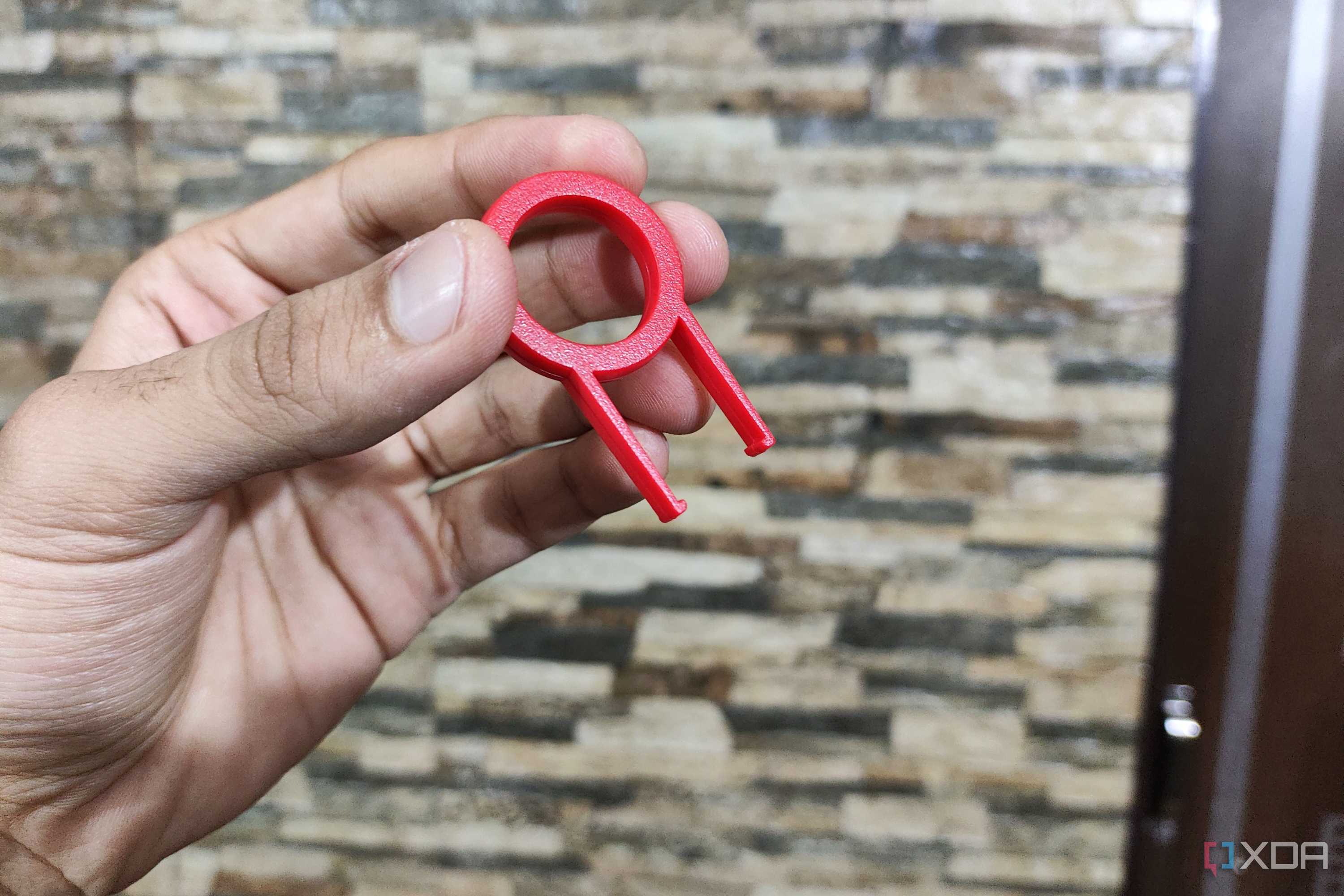 A person holding a keycap puller