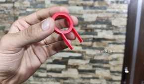 A person holding a keycap puller