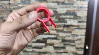 A person holding a keycap puller