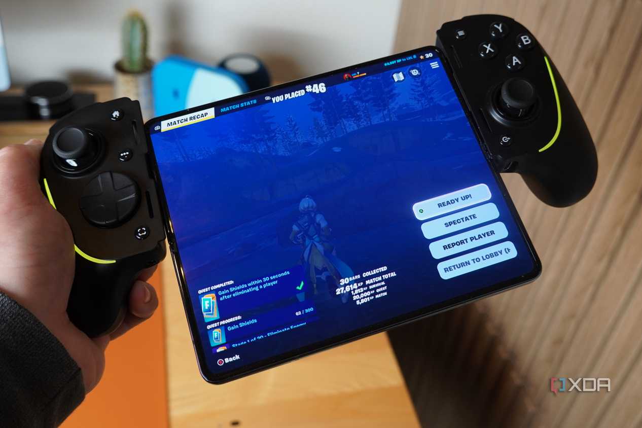 The Razer Kishi Ultra in hand connected to a foldable.