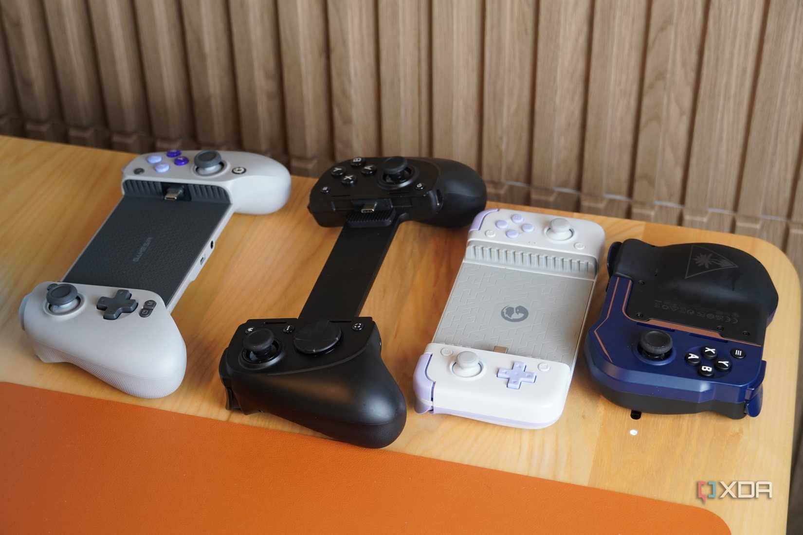 A lineup of mobile gaming controllers on a desk.