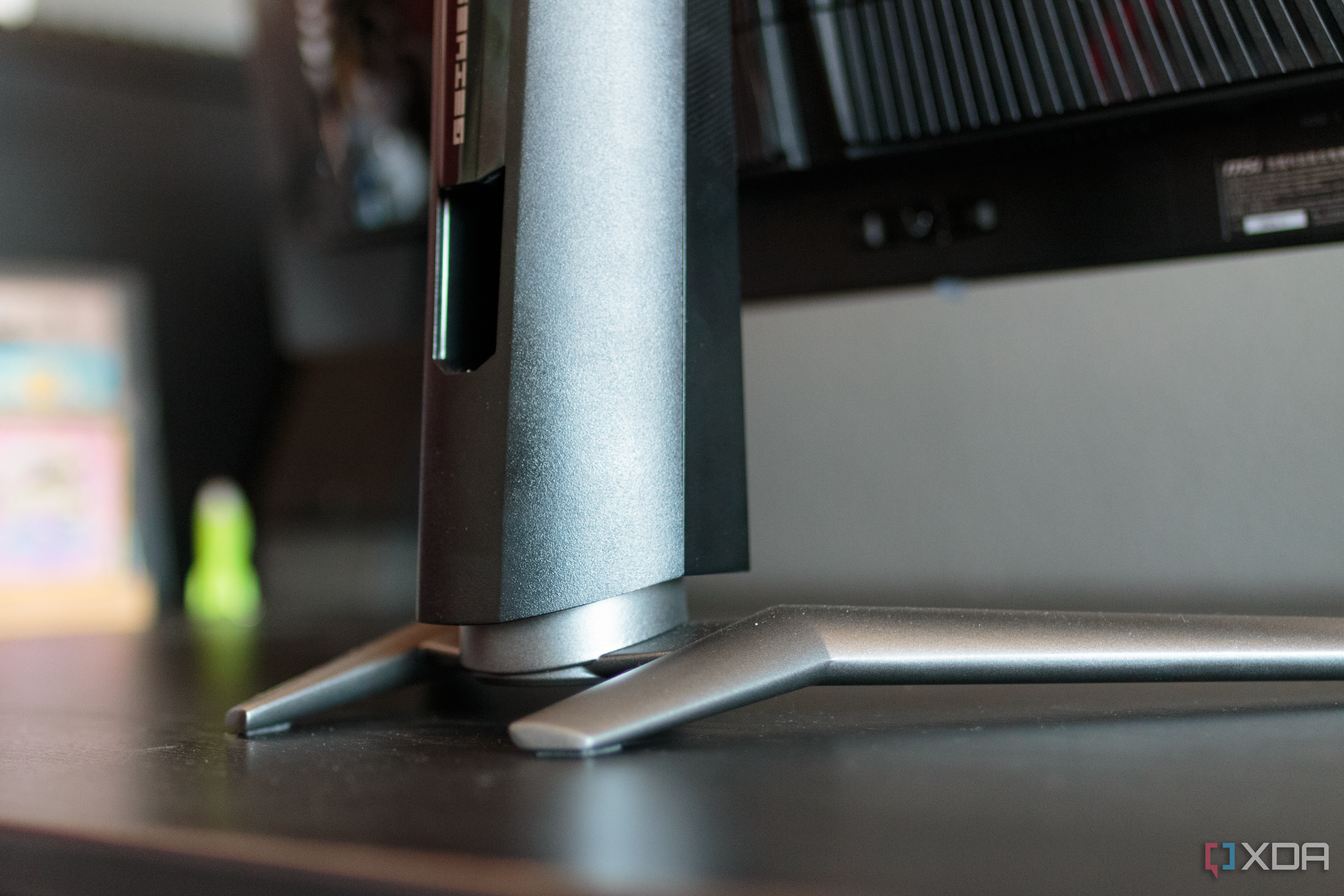 A close-up of the rear of the feet and stand of the MSI MAG 341CQP.
