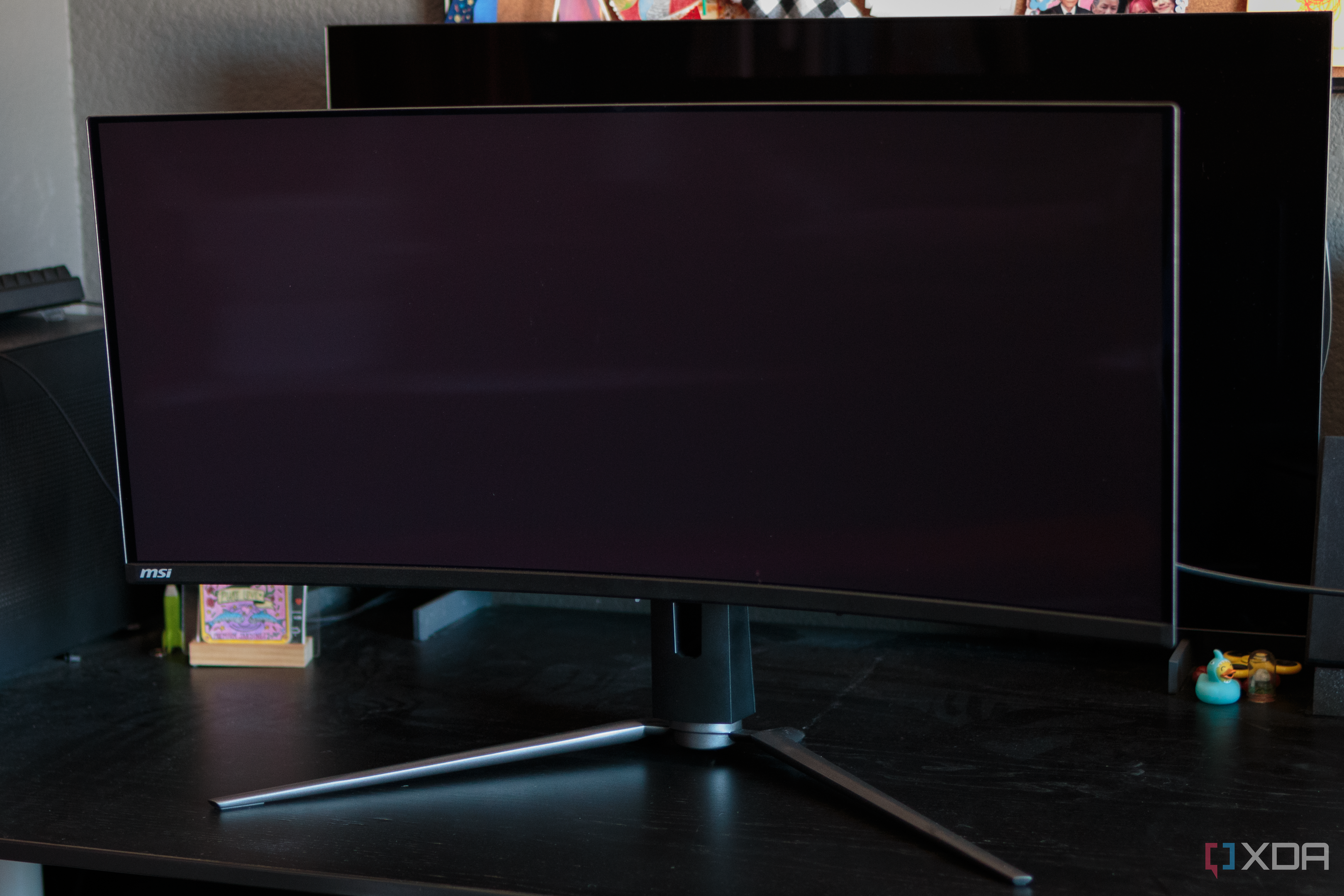 A comparison of the black levels with the MSI MAG 341CQP QD-OLED in the front and the LG 42C2 W-OLED behind it.