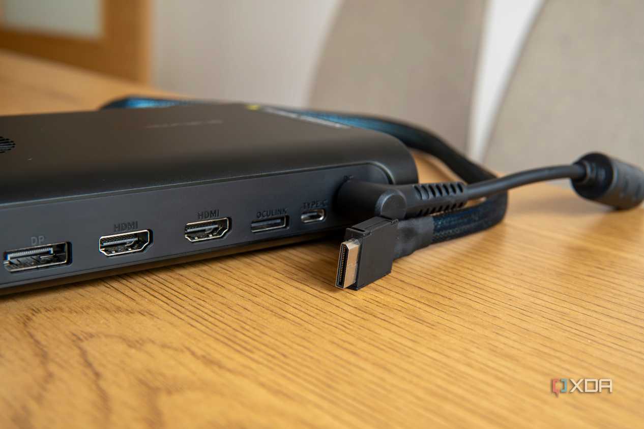 Close-up of an external GPU with an OCuLink port and an OCuLink cable next to it