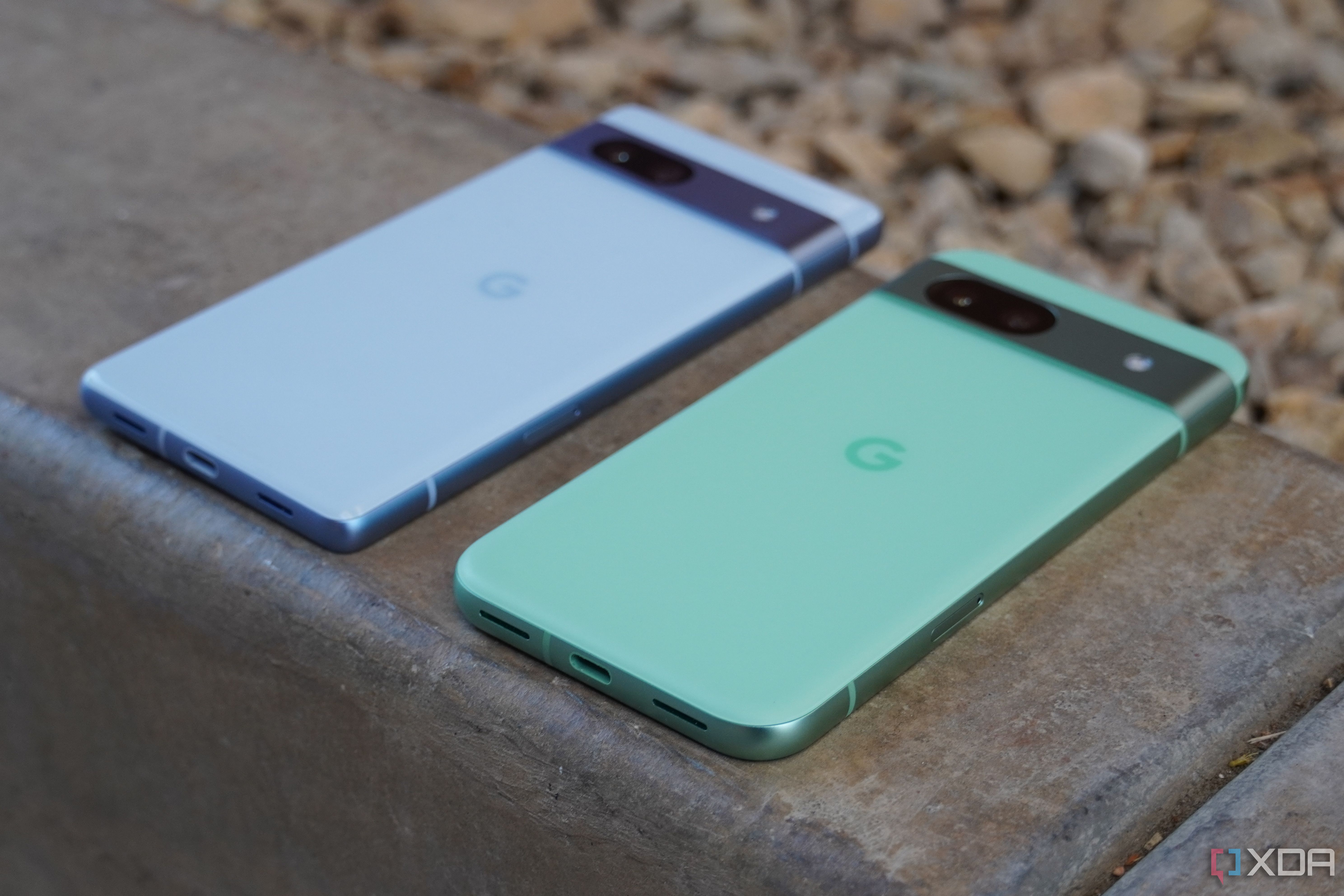 An angled view of the Pixel 7a and Pixel 8a.