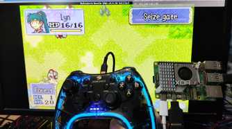 A Raspberry Pi 5 and a controller held in front of a PC screen