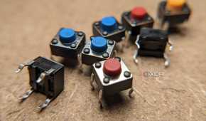 Eight small buttons on a wooden workbench
