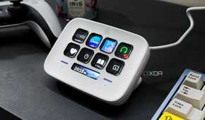 An image showing a Stream Deck Neo that's kept on a desk next to a keyboard and a PS5 DualSense controller.