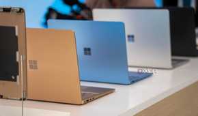 Surface laptops in multiple colors placed on a white surface