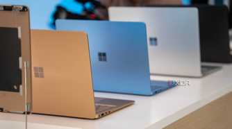 Surface laptops in multiple colors placed on a white surface